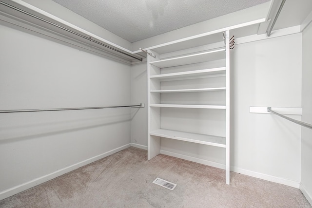 spacious closet with carpet and visible vents