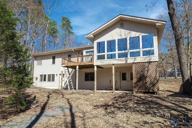 back of house featuring a wooden deck and stairs