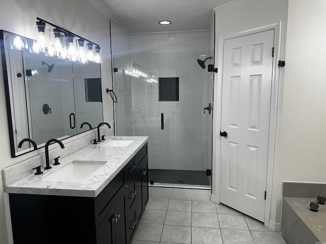 bathroom featuring ornamental molding, a stall shower, tile patterned flooring, and a sink