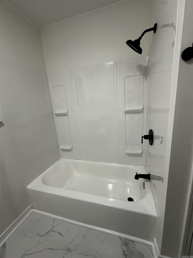 bathroom with marble finish floor, baseboards, ornamental molding, and shower / bathtub combination