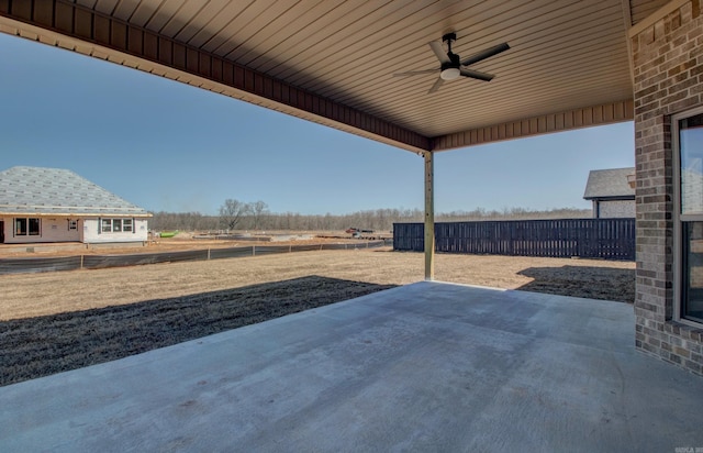 view of patio / terrace with ceiling fan and fence