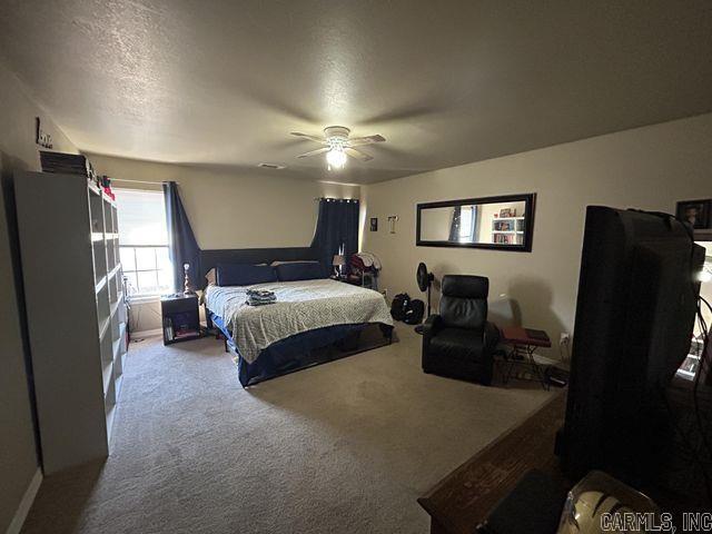 bedroom with a ceiling fan and carpet flooring