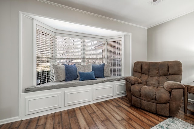 living area with visible vents, dark wood finished floors, and ornamental molding