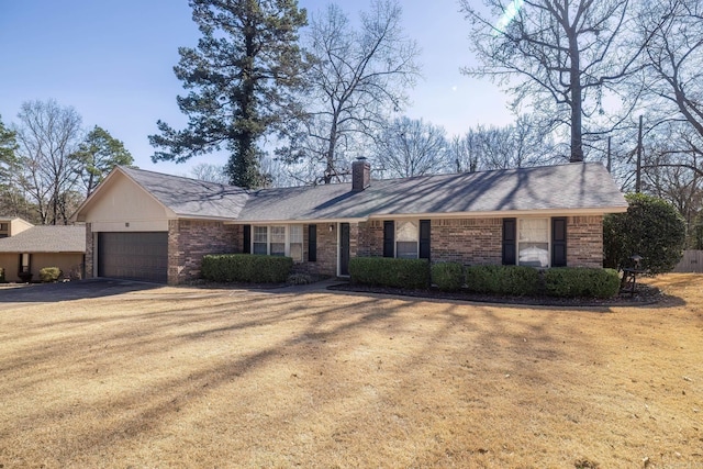 ranch-style house with driveway, a garage, a chimney, and brick siding