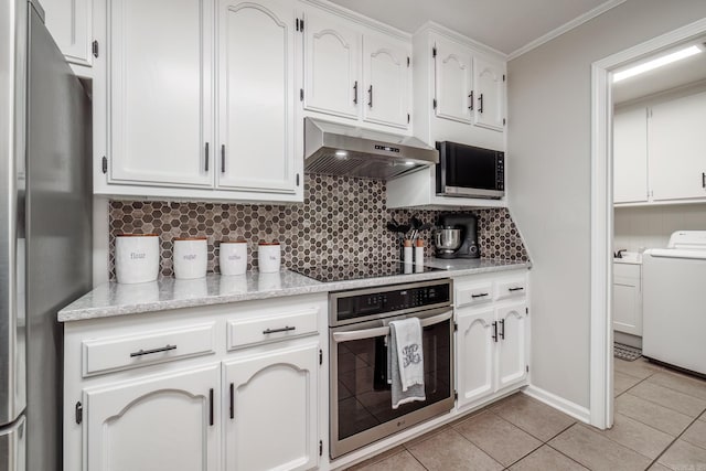 kitchen featuring light tile patterned floors, extractor fan, white cabinets, appliances with stainless steel finishes, and decorative backsplash