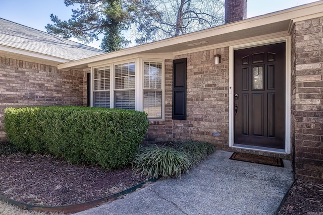 entrance to property with brick siding