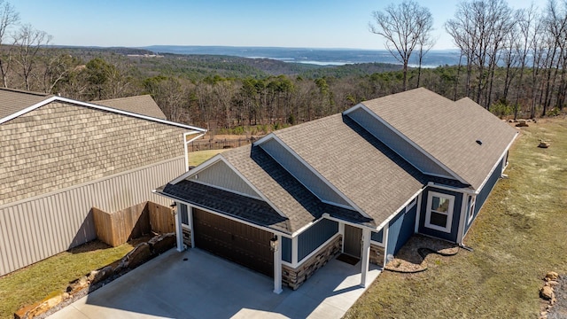 drone / aerial view with a wooded view