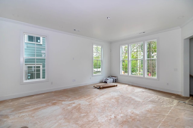 empty room with baseboards and crown molding