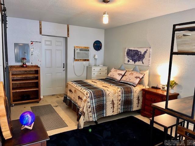 bedroom featuring concrete floors and electric panel