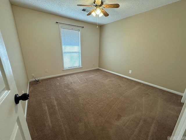 empty room featuring a textured ceiling, ceiling fan, visible vents, baseboards, and carpet