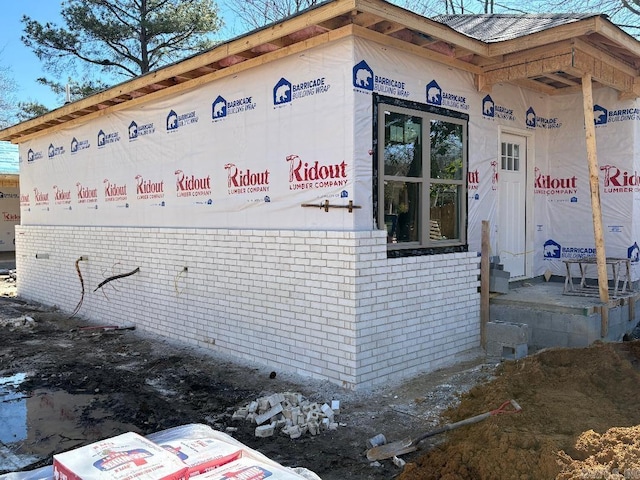 view of side of property featuring brick siding