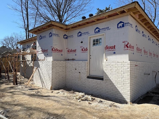 view of home's exterior with brick siding