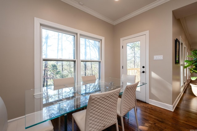 dining space with ornamental molding, dark wood-style flooring, and baseboards