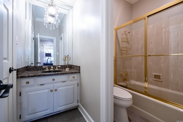 bathroom featuring toilet, enclosed tub / shower combo, vanity, tile patterned flooring, and baseboards