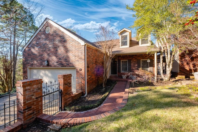 view of front of property with an attached garage, fence, a front lawn, and brick siding