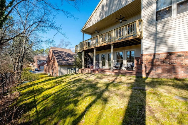 rear view of property with ceiling fan, a patio, and a lawn