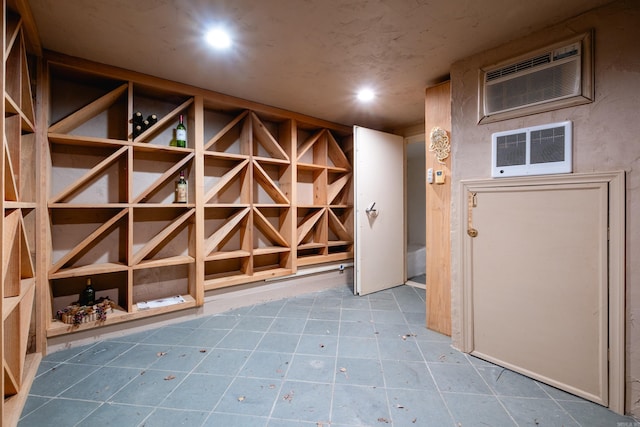 wine area featuring a wall unit AC, visible vents, and recessed lighting