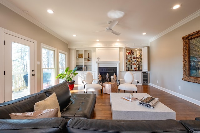 living area featuring dark wood-style floors, wine cooler, and crown molding