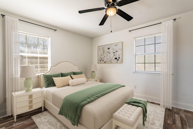 bedroom featuring ceiling fan, baseboards, and wood finished floors