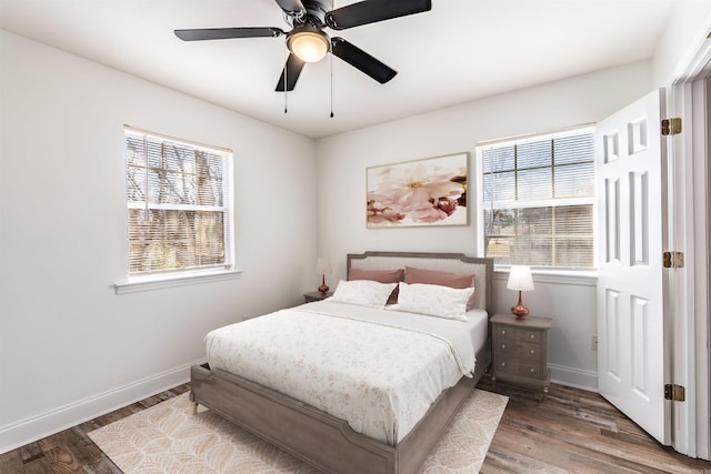 bedroom featuring wood finished floors, a ceiling fan, and baseboards