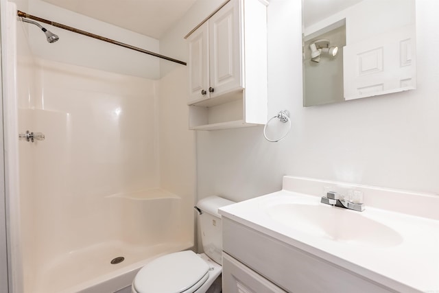 full bath with toilet, a stall shower, and vanity