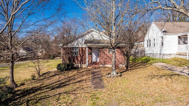 view of front of house with a front lawn and brick siding