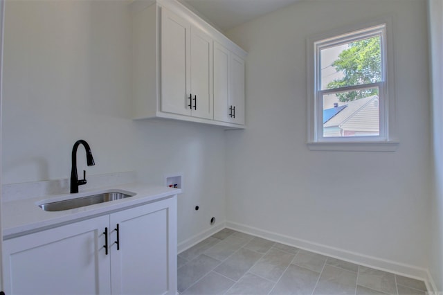 laundry area featuring washer hookup, a sink, baseboards, cabinet space, and electric dryer hookup