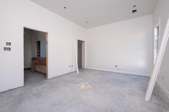 unfurnished bedroom featuring concrete floors and visible vents