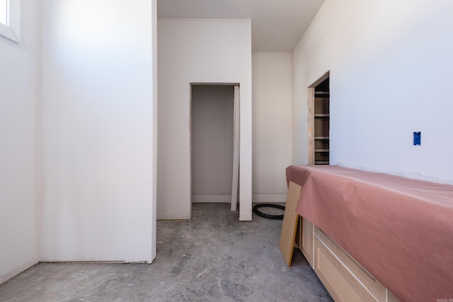 bedroom featuring unfinished concrete flooring