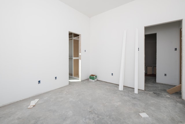 unfurnished bedroom with unfinished concrete floors