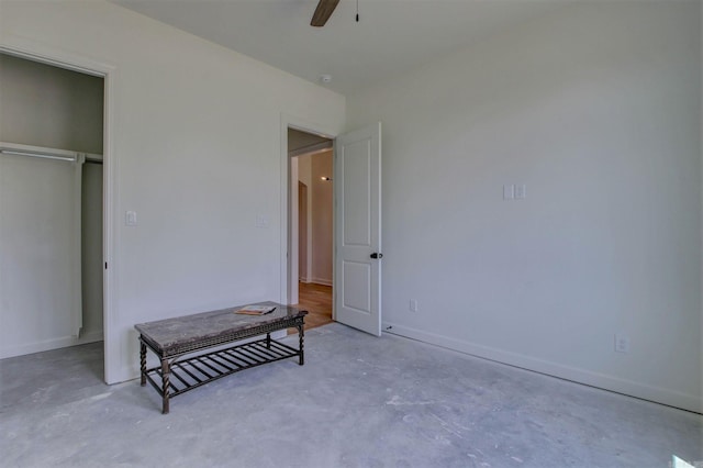 bedroom featuring ceiling fan and concrete floors