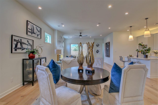 dining space featuring a ceiling fan, light wood-type flooring, baseboards, and recessed lighting