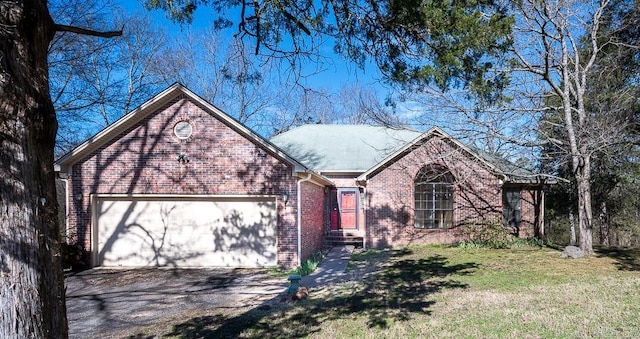 ranch-style house with aphalt driveway, a front yard, a garage, and brick siding