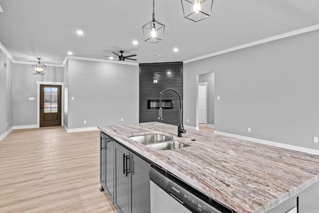 kitchen with dishwasher, open floor plan, hanging light fixtures, light wood-style floors, and a sink