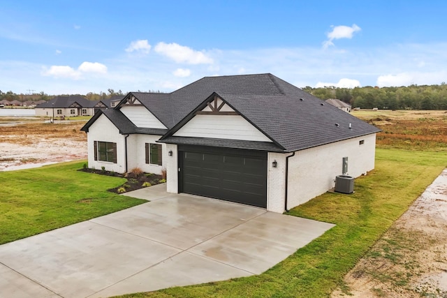 modern farmhouse with a garage, brick siding, a shingled roof, driveway, and a front lawn