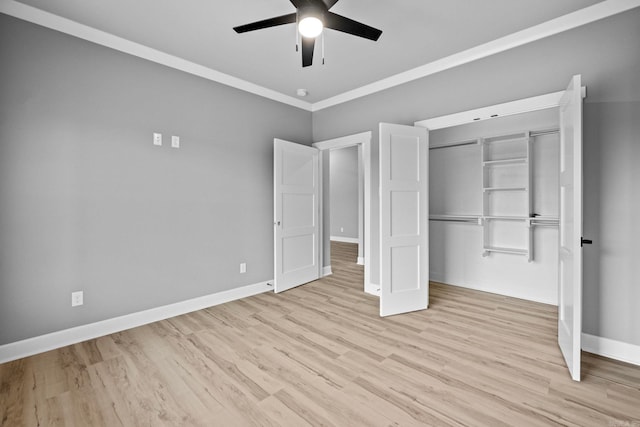 unfurnished bedroom with a ceiling fan, baseboards, ornamental molding, a closet, and light wood finished floors