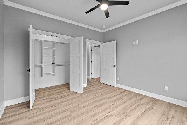 unfurnished bedroom with crown molding, a closet, light wood-style floors, ceiling fan, and baseboards