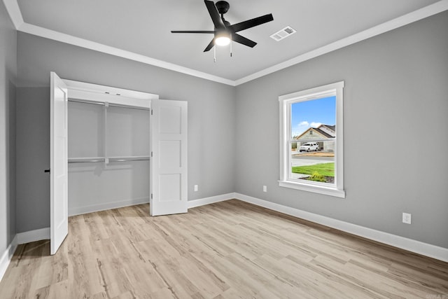 unfurnished bedroom featuring light wood-type flooring, visible vents, baseboards, and a closet