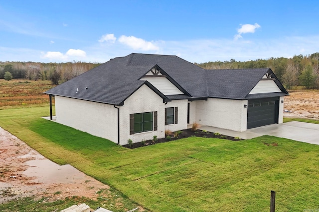 modern inspired farmhouse featuring driveway, brick siding, roof with shingles, an attached garage, and a front yard