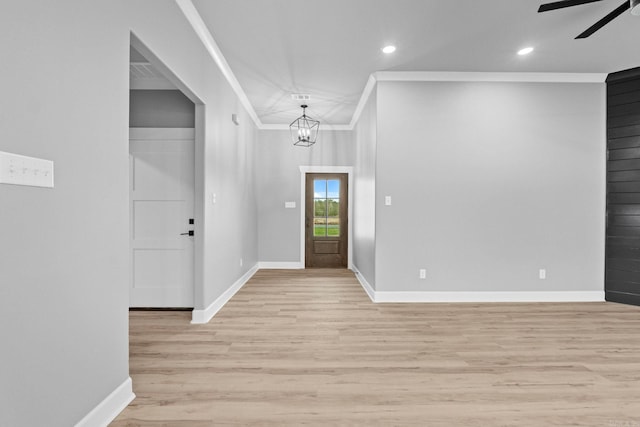 foyer entrance with baseboards, ornamental molding, and light wood-style floors