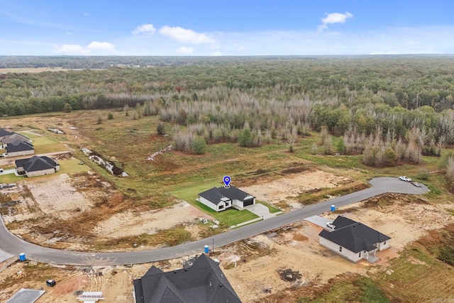 birds eye view of property featuring a view of trees