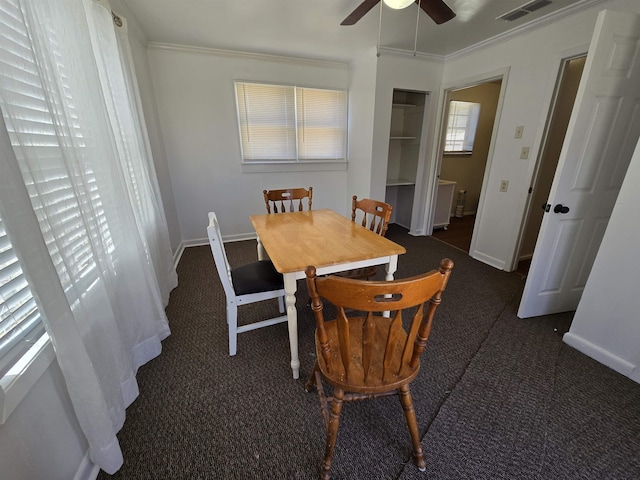 dining area with ceiling fan, carpet floors, visible vents, baseboards, and ornamental molding