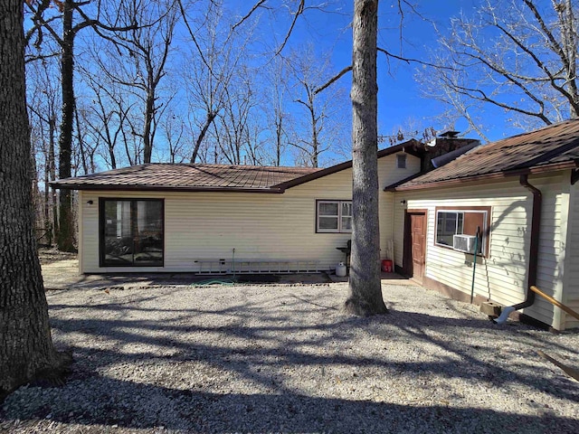 rear view of property with metal roof