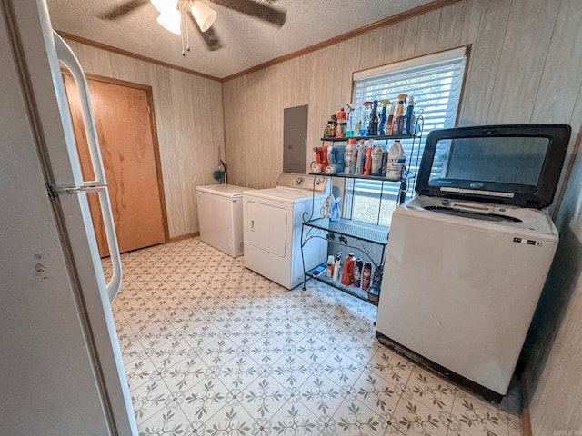 laundry room with laundry area, washing machine and dryer, light floors, and crown molding