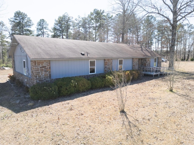 ranch-style house with stone siding