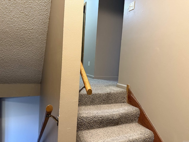 stairway with carpet floors and baseboards