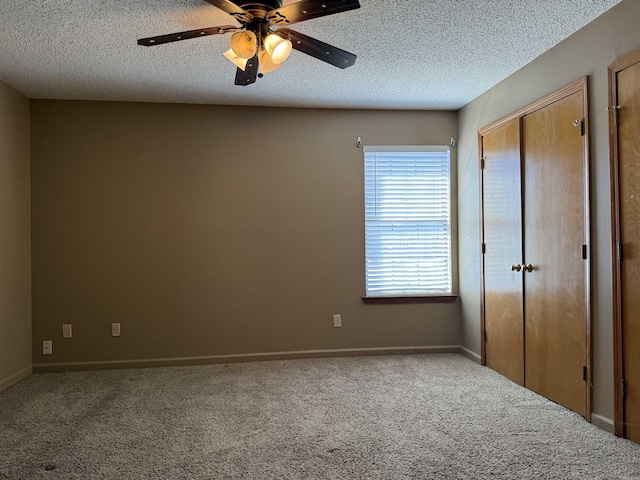 unfurnished bedroom with carpet floors, a ceiling fan, and a textured ceiling