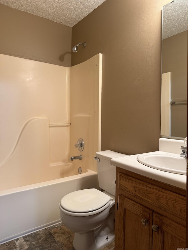 bathroom featuring bathtub / shower combination, a textured ceiling, toilet, and vanity