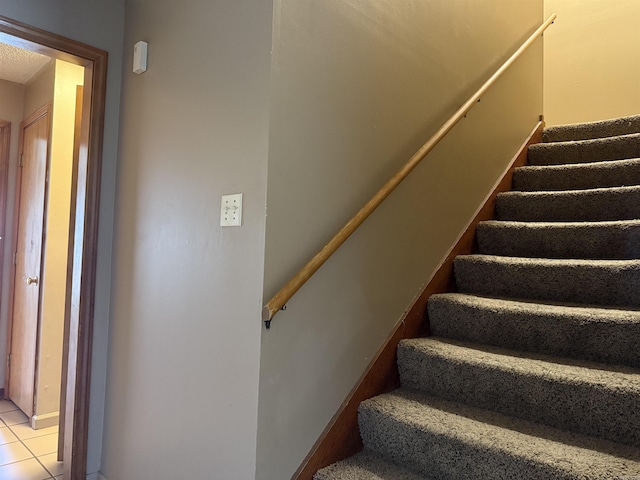 staircase with tile patterned flooring