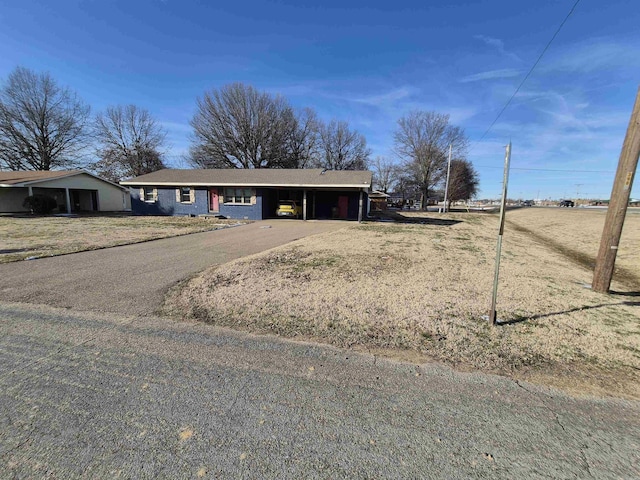 view of front of home featuring driveway and an attached carport